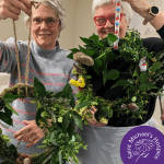 Volunteers at our Ripon shop hold their handmade Easter wreaths